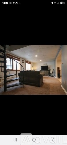 A living room with a couch and a television.