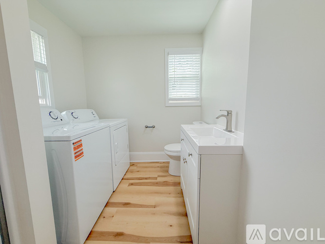 A small laundry room with a washer and dryer.