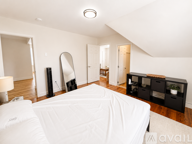 A room with wooden floors and two windows.