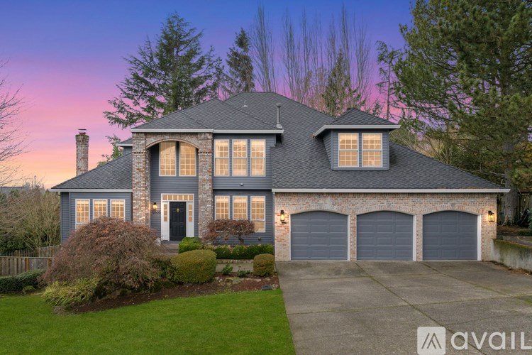 A house with a garage and a driveway is available for sale.