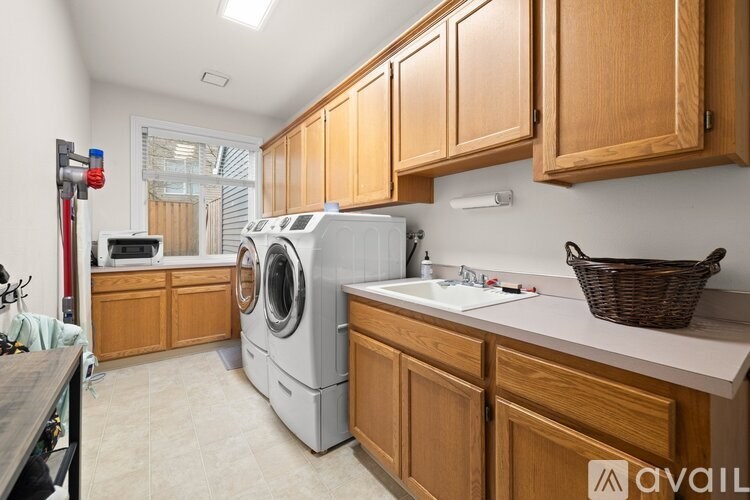 A kitchen with wooden cabinets and a washing machine.
