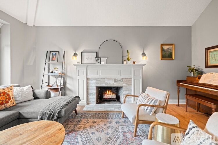 A cozy living room with a fireplace and comfortable seating.