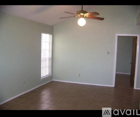 A room with a ceiling fan and a window.