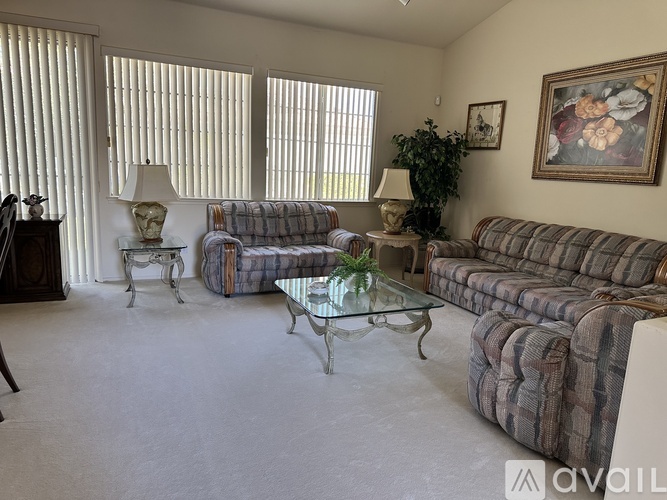A living room with a couch, chair, and table.