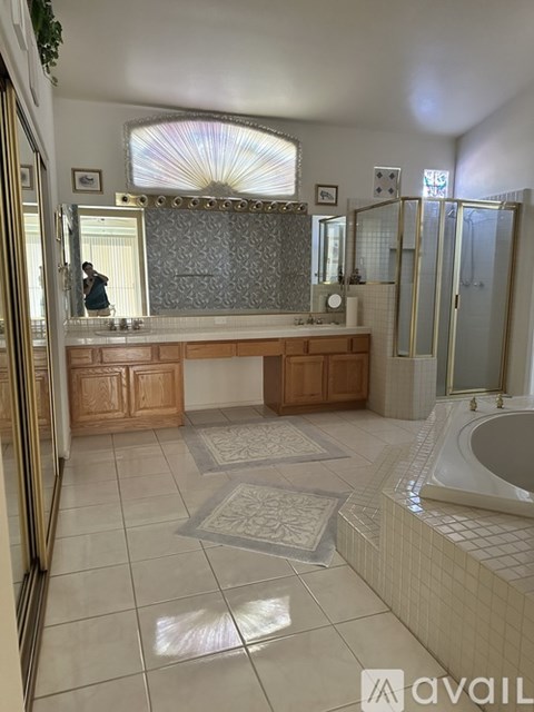 A bathroom with a large mirror and a bathtub.