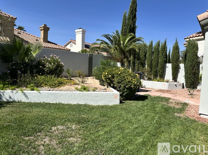 A well-maintained garden with a variety of plants and trees.