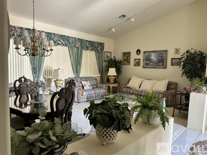 A dining room with a wooden table and chairs.