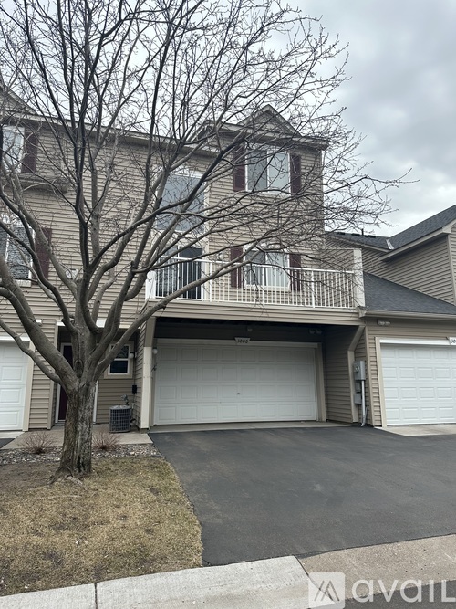 A house with a tree in front of it.