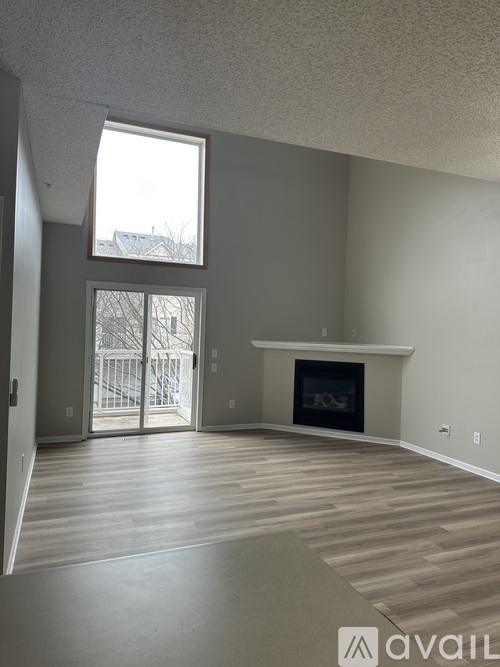 A living room with a fireplace and sliding glass doors.
