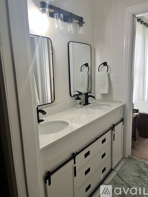 A bathroom with a sink and mirror.