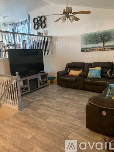 A living room with a television and a couch.