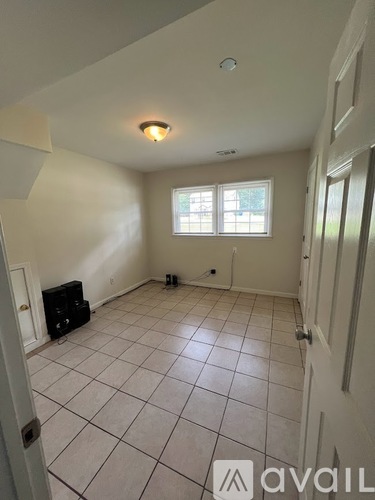 A room with a tiled floor and a window.