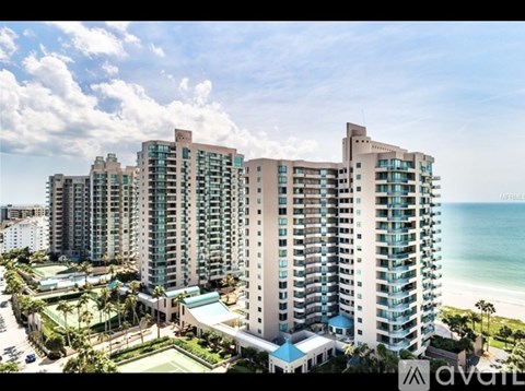 A large building with a pool in front of it.