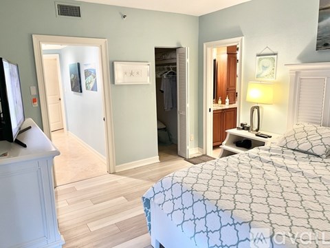 A bedroom with a large bed and a television.