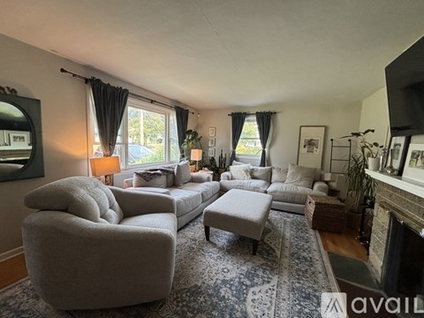 A living room with a grey sofa and a grey armchair.