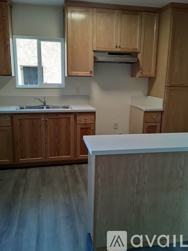 A kitchen with wooden cabinets and a counter top.