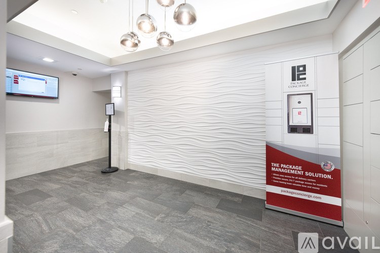 A room with a poster on the wall and a vending machine.