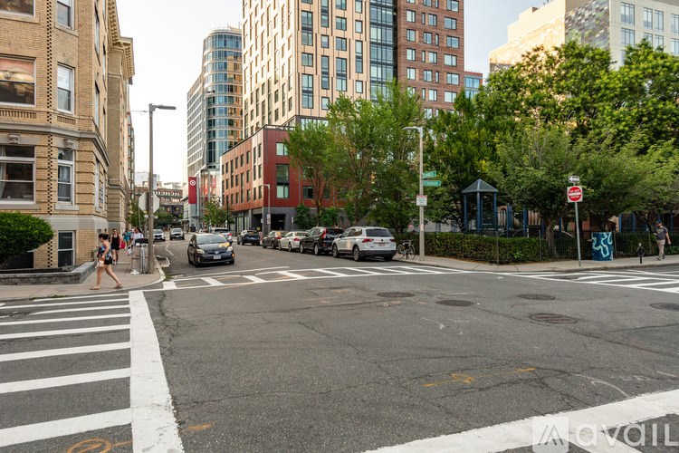 A city street with cars and buildings.