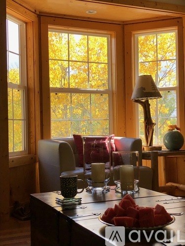 A table with a plate of watermelon and glasses on it.