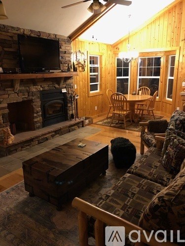 A cozy living room with a fireplace and a television.