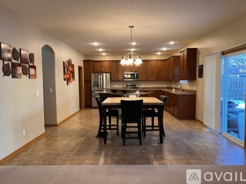 A kitchen with a table and chairs in the middle of the room.