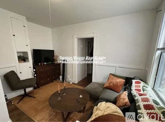 A living room with a brown table and a green chair.