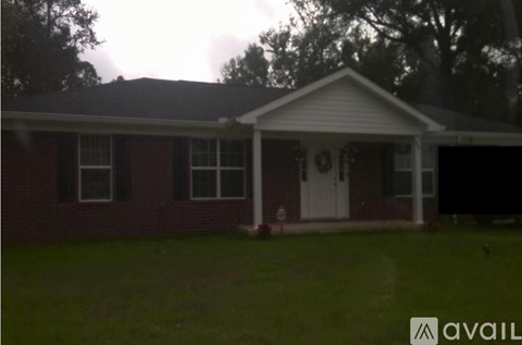 A house with a red brick exterior and a white door is available for purchase.