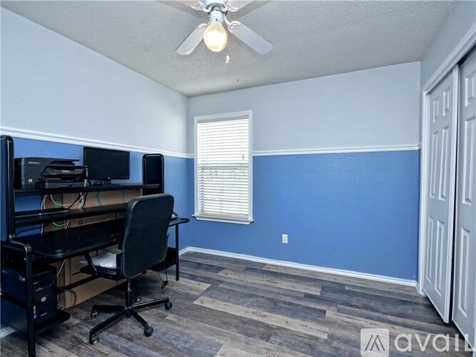 A room with a desk and a computer.