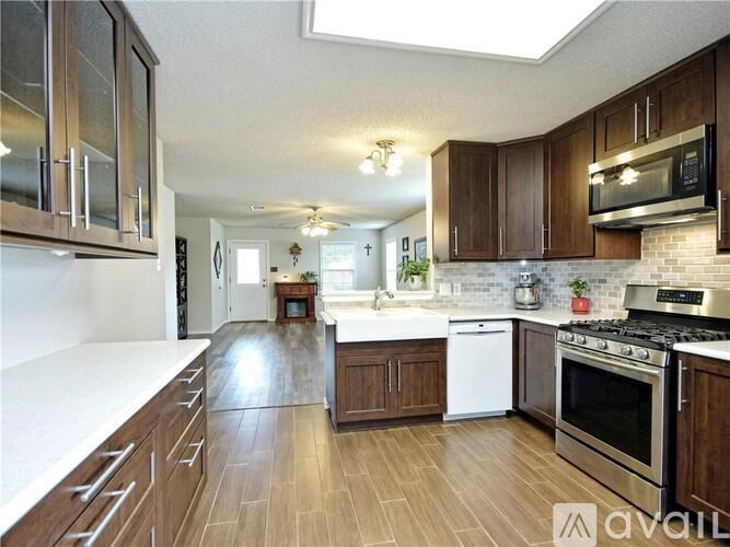 A kitchen with wooden cabinets and a white countertop.