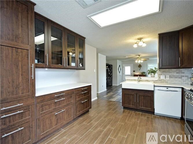 A kitchen with wooden cabinets and a white countertop.