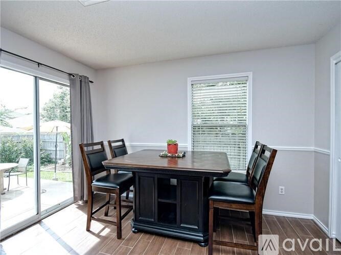 A dining room with a table and chairs.