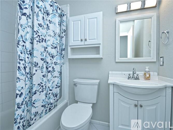 A white toilet sits next to a sink in a bathroom.