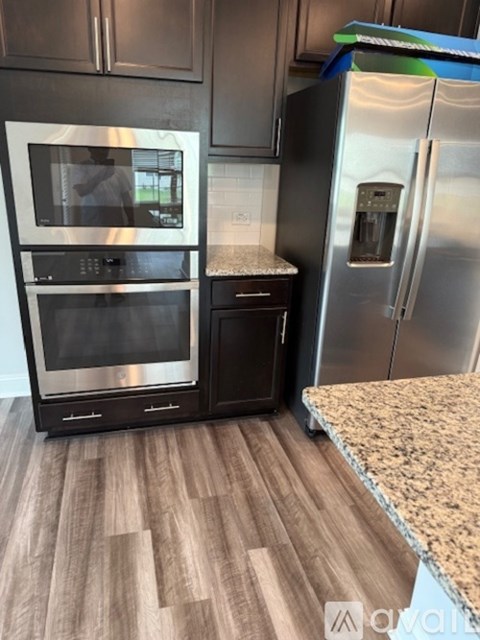 A kitchen with a stainless steel refrigerator and oven.