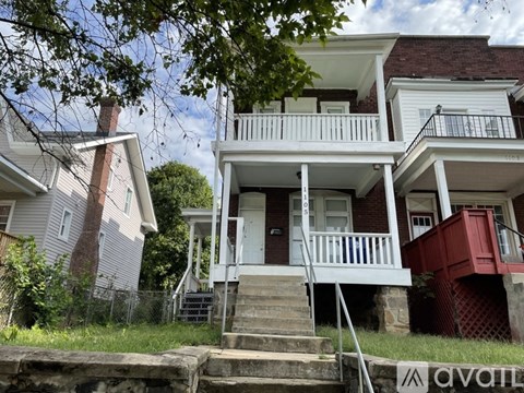 A house with a red door and white railings.