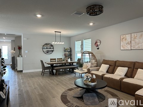 A living room with a brown couch and a coffee table.