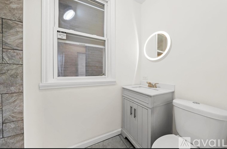 A bathroom with a tub, sink, and a window.