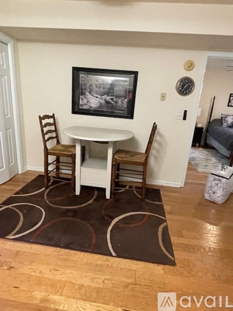 A small dining room with a table and chairs.