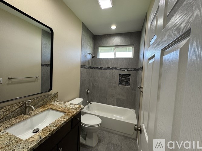 A bathroom with a sink, toilet, and bathtub.