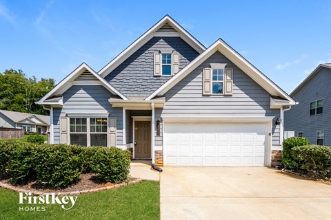 A house with a garage and a driveway is for sale.
