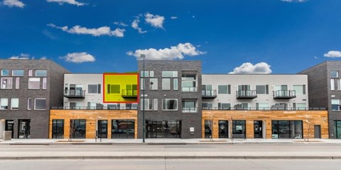 A modern building with a yellow square in the middle of it.