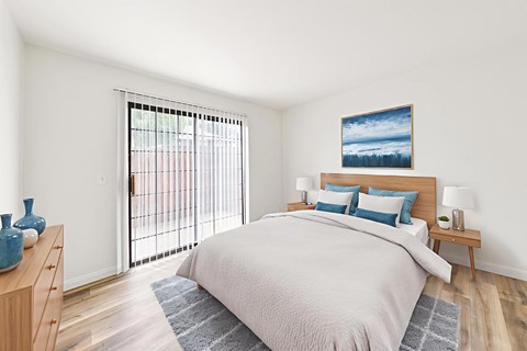 A bedroom with a large bed and a painting on the wall.