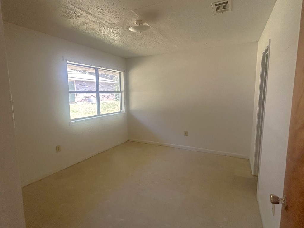 A room with a window and a door.