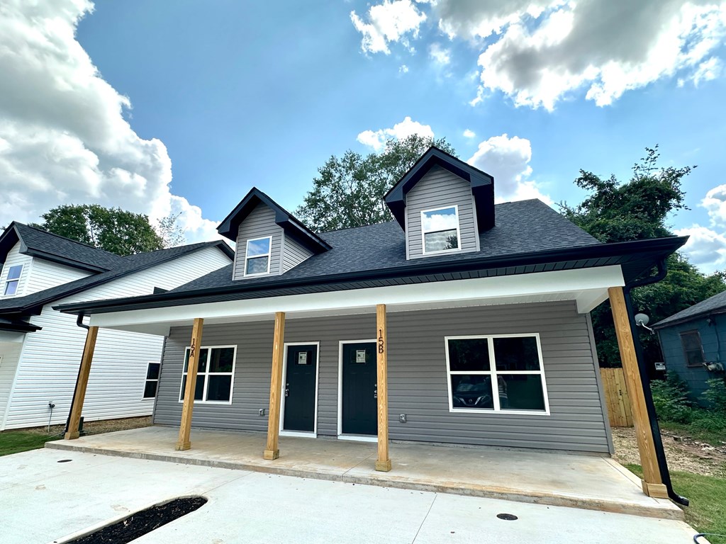 A house under construction with a grey roof and a white garage door.