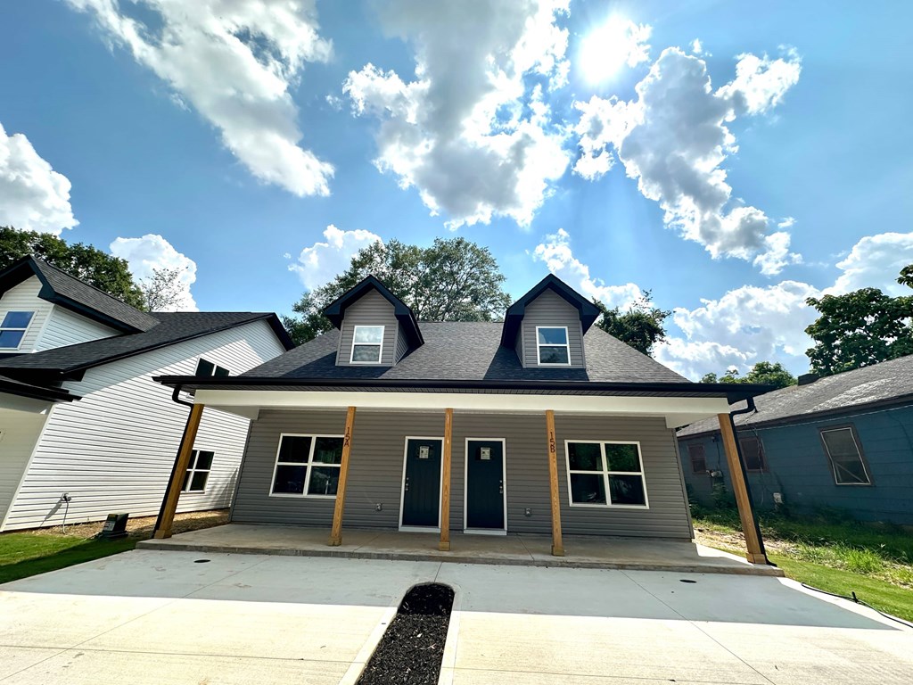 A house with a grey roof and a white garage door.