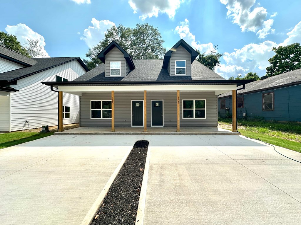 A house with a grey roof and a grey garage door.