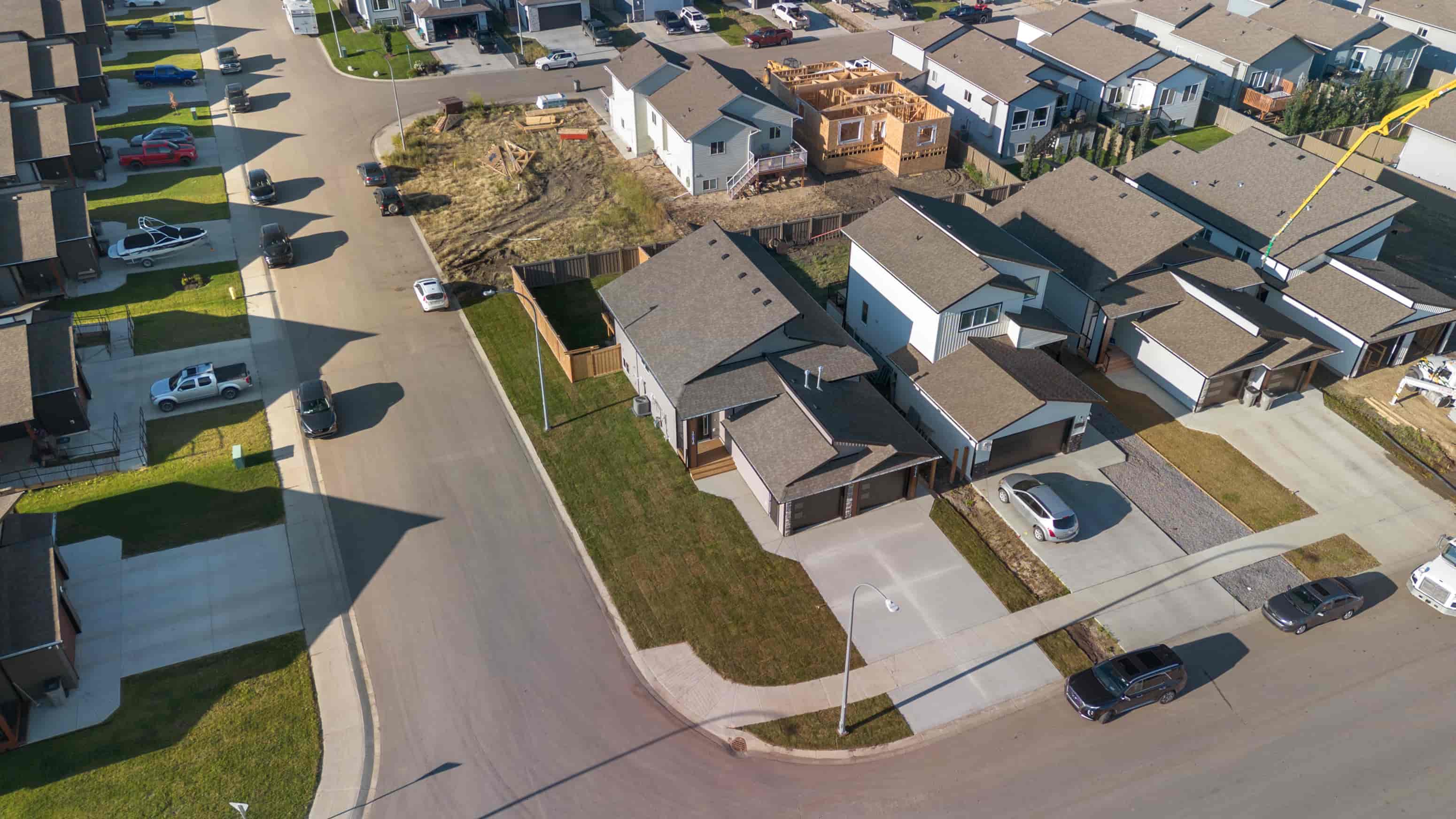 A residential area with houses and cars.