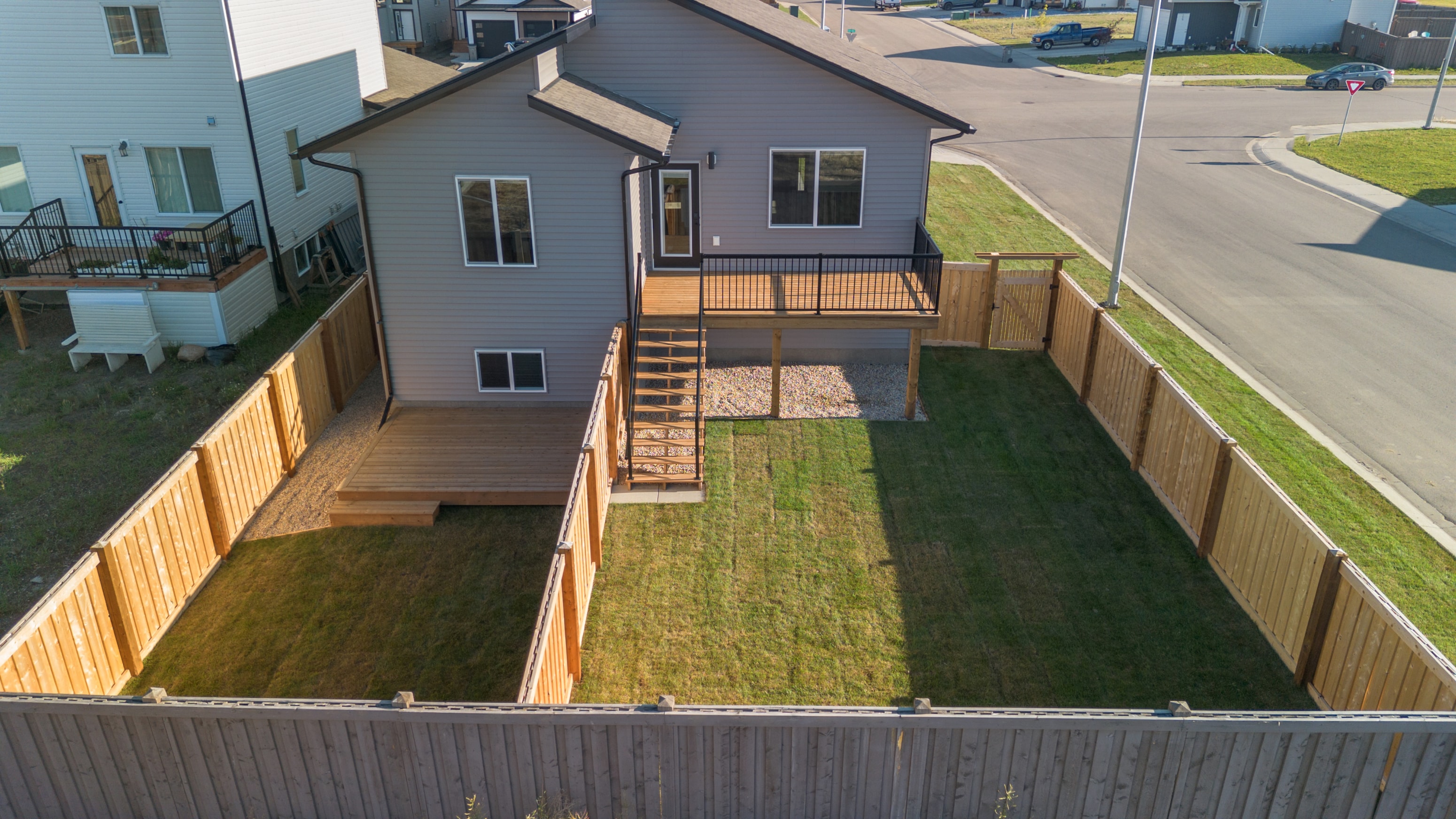 A house with a grey roof and a wooden deck.