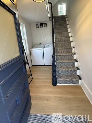 A hallway with a staircase leading to the second floor.
