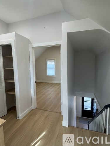 A room with a staircase and a window.