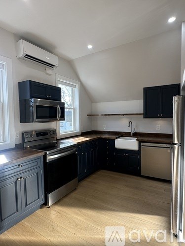 A kitchen with a stove, oven, and sink.